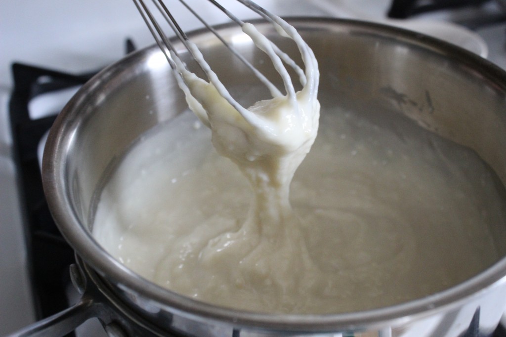 Showing the whisk with the cooked flour and milk